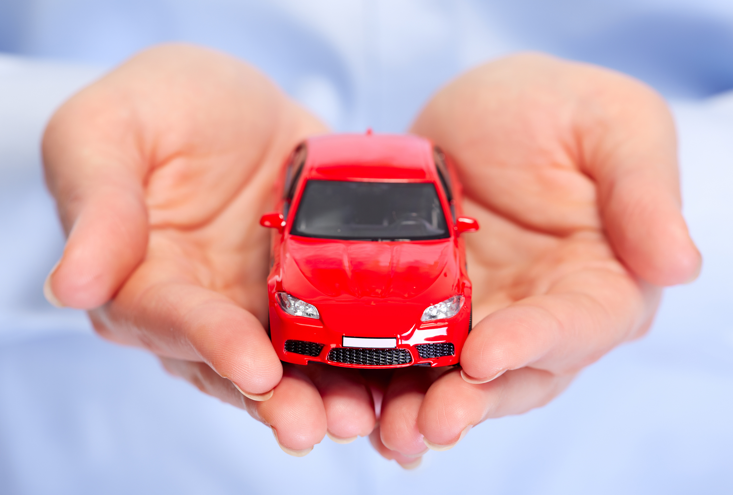 Hand with car. Auto dealership and rental concept background.